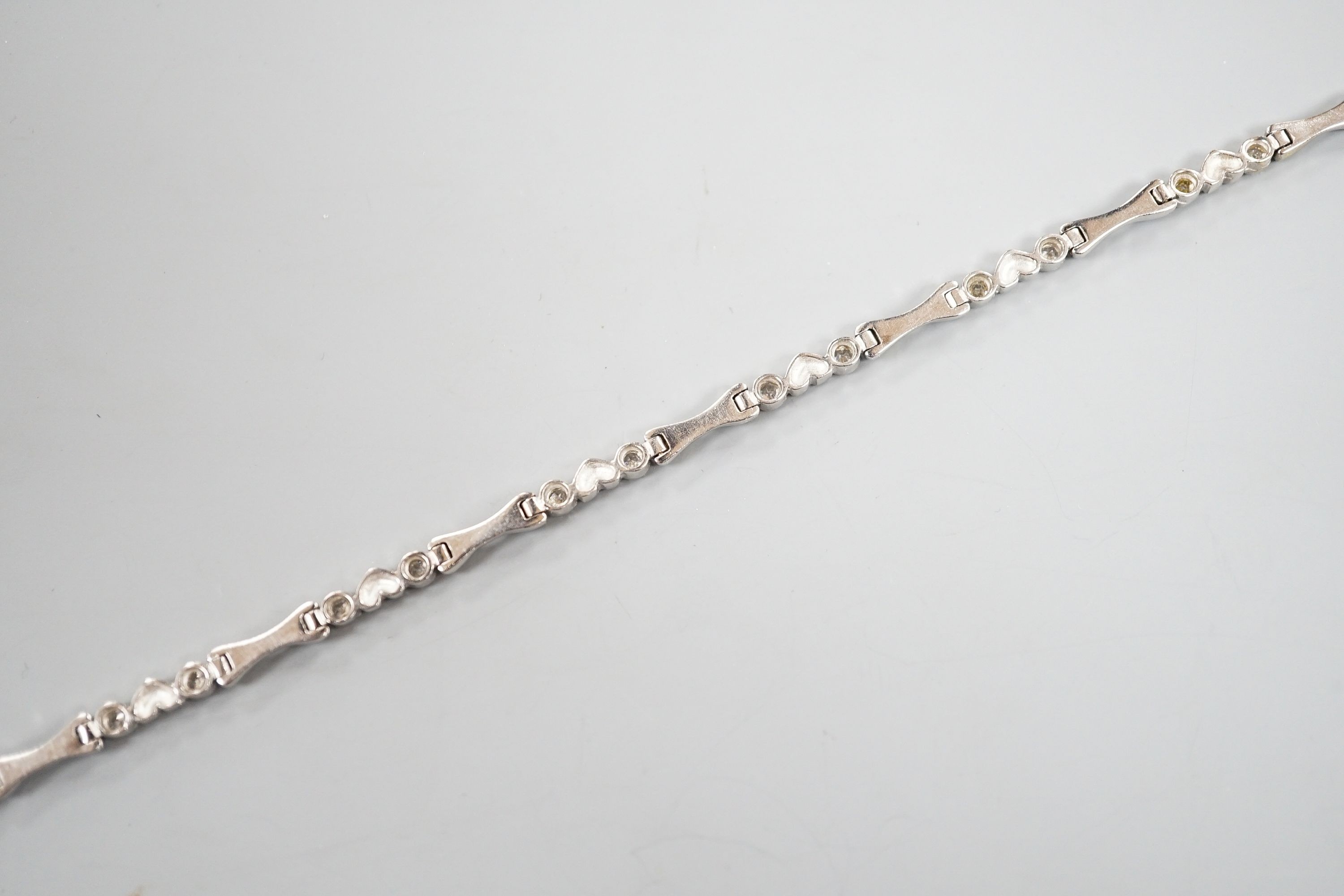 A modern 750 white metal and sixteen stone diamond set line bracelet, 19.2cm, gross weight 12.9 grams.